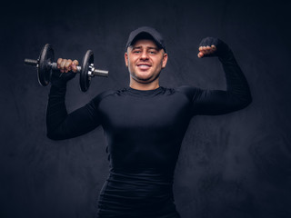 A handsome man, dressed in a black sportswear.