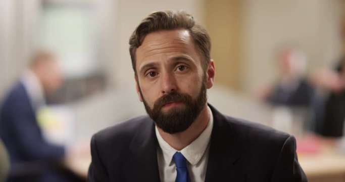 4K Businessman trying to look interested during very boring conference call in the office