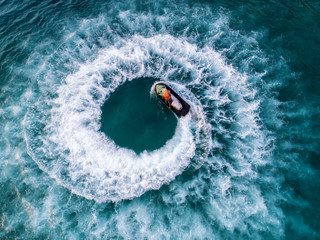 People are playing a jet ski in the sea.Aerial view. Top view.amazing nature background.The color...