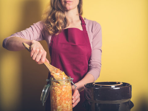 Young woman making kimchi