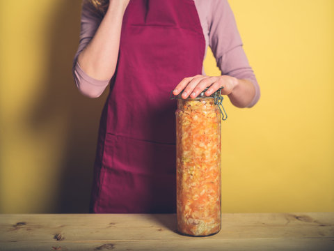Young woman with massive jar of kimchi