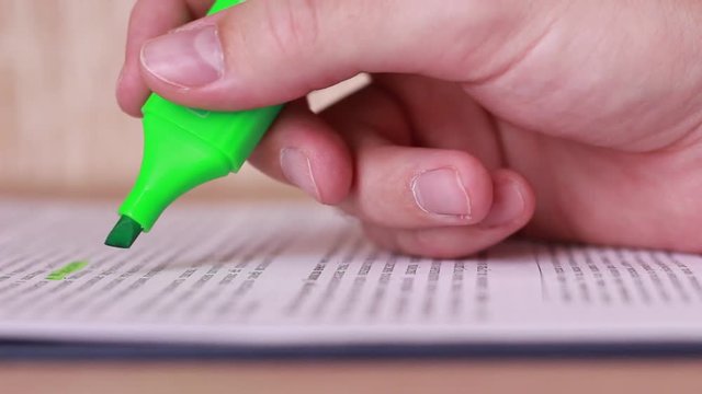 Highlighting article with green marker closeup