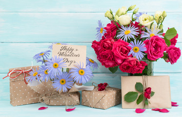 Valentine day theme. Roses and daisy bouquet, greeting card with gifts on wooden background in Shabby Chic style