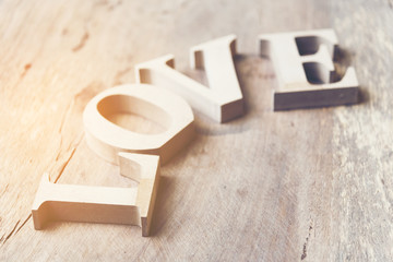 Wooden letters forming word LOVE written on wooden background