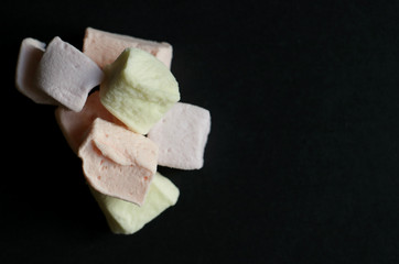 colorful tasty cubes marshmallow an black table 