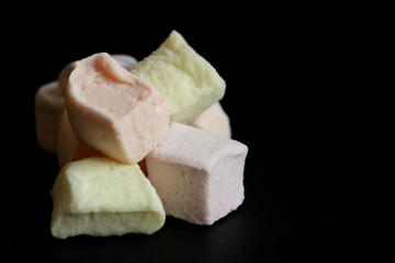 colorful tasty cubes marshmallow an black table 