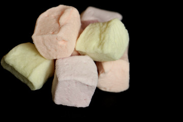 colorful tasty cubes marshmallow an black table 