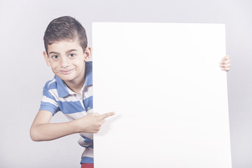 Boy holding a blank white sign with copy space
