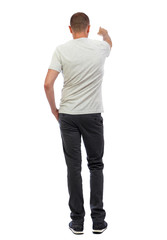 Fototapeta premium Back view of pointing young men in shirt and jeans.