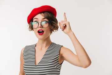 Portrait of an excited woman wearing red beret pointing