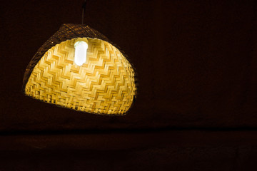 Lighting from light bulb in the bamboo weave hanging lamp