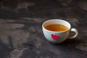 Cup of tea with heart shaped teabag tag