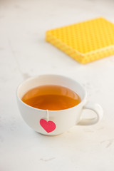 Cup of tea with heart teabag and gift boxes