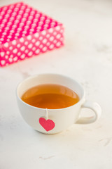 Cup of tea with heart teabag and gift boxes