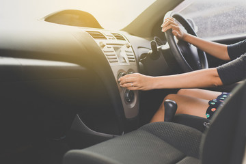 Hand of man turning on car air conditioning system,Button on dashboard in car panel