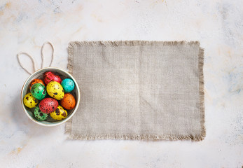Colored easter eggs on a light canvas background,place for text