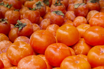Persimmon for sale on booth at market.
