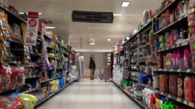 Supermarket Aisle Slow Motion. Slow motion of a shopping cart in the supermarket aisle with products and people