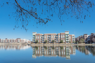 Riverside apartment building complex reflection blue sky