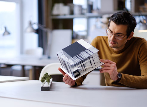 Man working with maquette in design and engineering architecture office