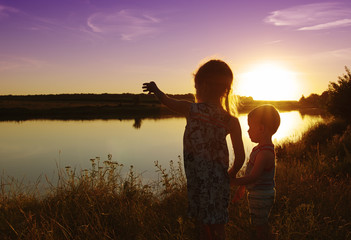 Fototapeta premium little boy and girl in the field