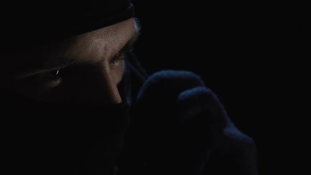 Criminal speaking on phone expressing his condition, demanding ransom for victim