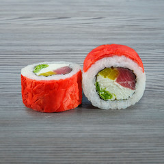 Sushi rolls on a wooden gray background