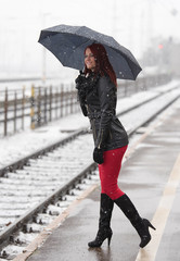 Young woman waiting for a train in the station