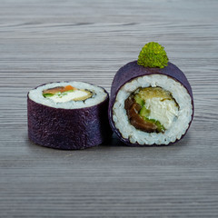Sushi rolls on a wooden gray background