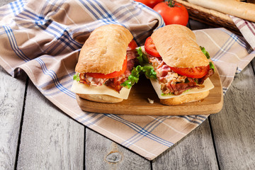 Ciabatta sandwich with smoked bacon, cheese and tomato