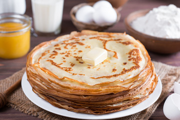 Traditional Ukrainian or Russian pancakes on a plate with butter. Russian bliny.