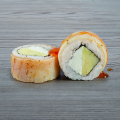 Sushi rolls on a wooden gray background