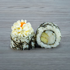Sushi rolls on a wooden gray background