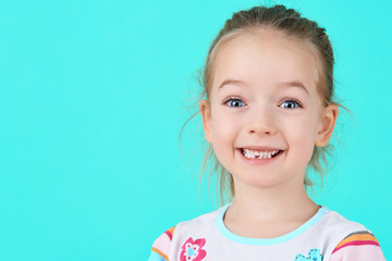 Adorable little girl smiling and showing off her first lost milk tooth. Cute preschooler portrait after dropping her front baby tooth. - obrazy, fototapety, plakaty
