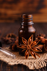 essential oil of the anise stars on a dark rustic background