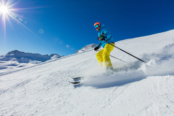 Young man skiing downhill in Alps