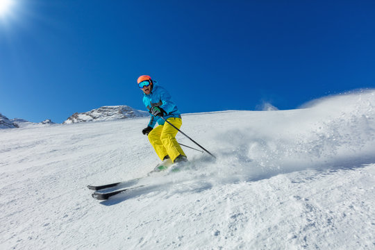 Young man skiing downhill in Alps