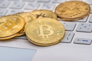 bitcoin on white laptop close up