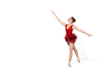 the ballerina in pointes and a red dress sits on a white background
