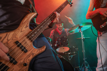 Obraz na płótnie Canvas Guitarist and bass player perform on stage.