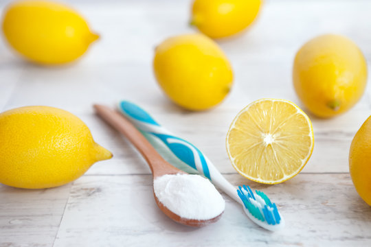 Baking soda, tooth brush and lemons