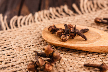 essential oil of cloves on a wooden rustic background