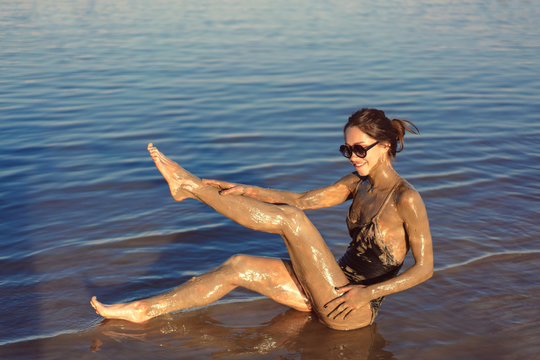 A young woman enjoying the natural mineral mud