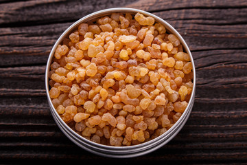frankincense essential oil on a wooden background