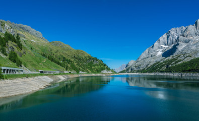 Fototapeta na wymiar Lago Fedaia (Fedaia Lake), Fassa Valley, Trentino Alto Adige, an artificial lake and a dam near Canazei city, located at the foot of Marmolada massif.