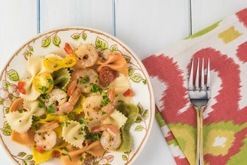 Shrimp veggie colorful bowtie pasta.