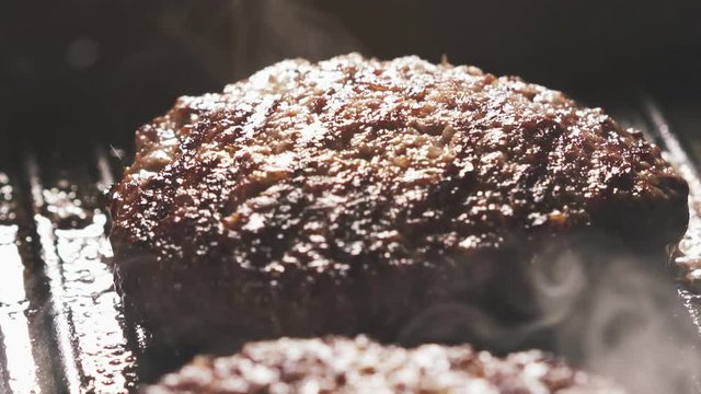 beef patty preparing on grill pan in 180fps slow motion