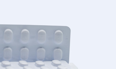 Macro shot detail of tablets pill in white blister pack for light resistance packaging isolated on white background. Medicine for treatment NCDs. Elderly people disease.