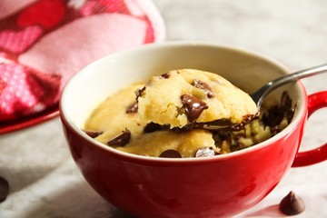 Homemade Microwave Chocolate chip cookie in a mug, selective focus