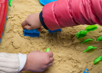 kids playing sand and plastic moulds